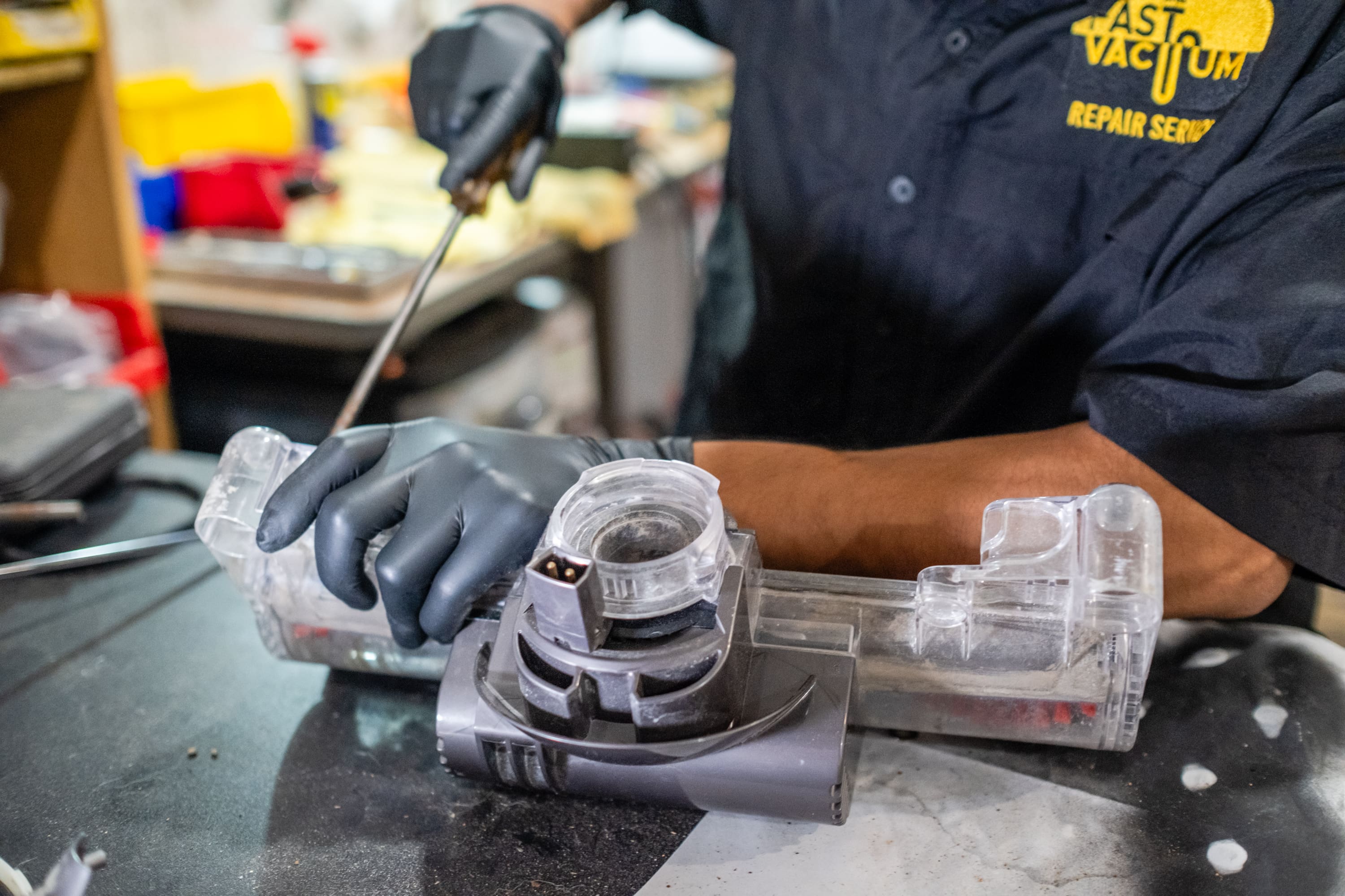 A person wearing gloves and working on something.