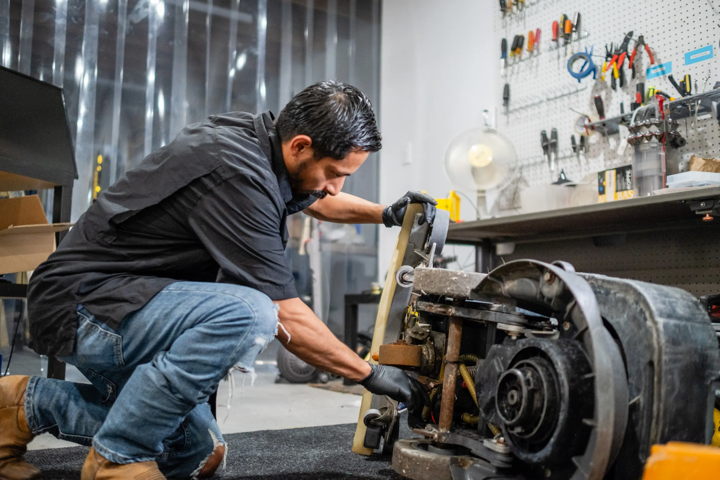 A man working on an engine in a garage.